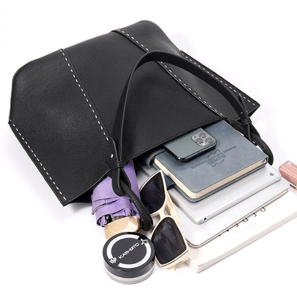 Kontrastsömmar texturerade tygväskor i äkta läder