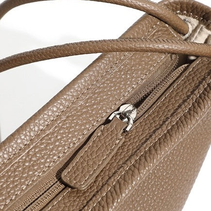 Minimalistisk asymmetrisk design med lös hornformad axelremsväska